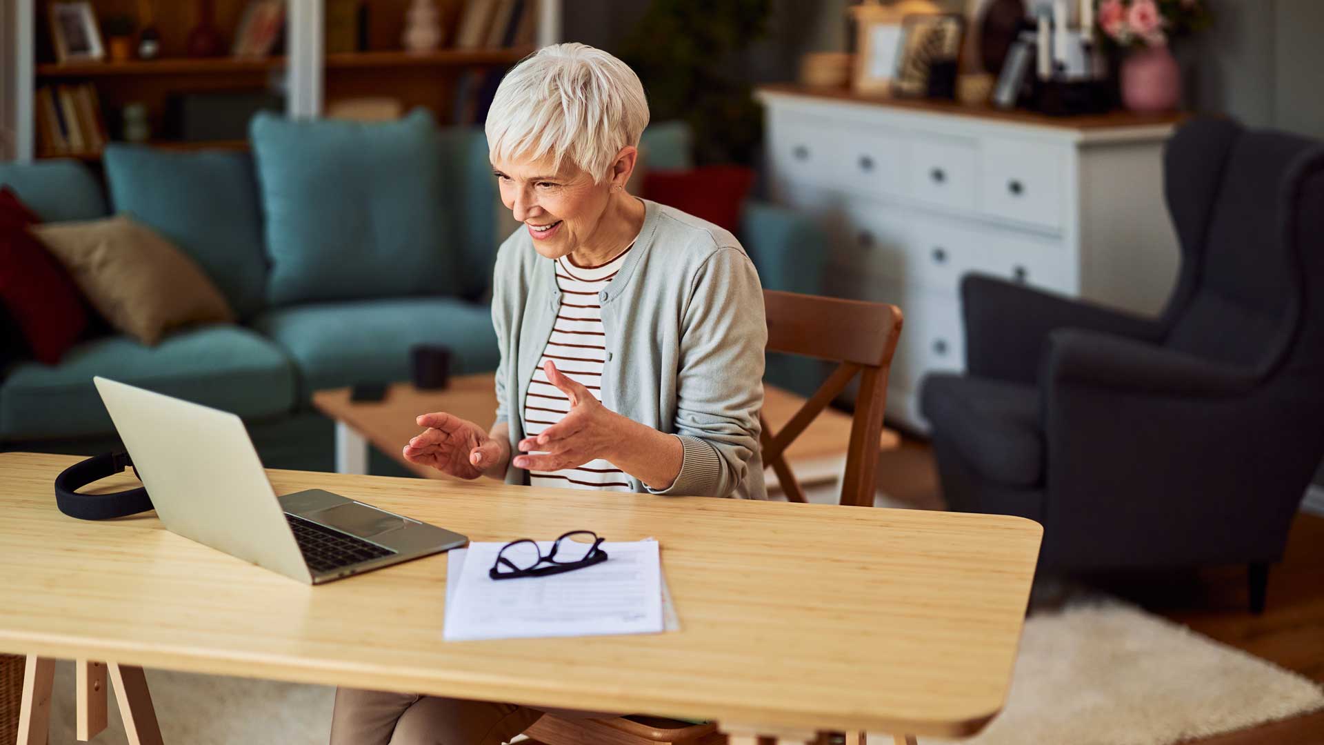 A professional senior adult female entrepreneur working from home and having a video call with her coworkers, ekas, patients market research